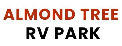 Text reading "Almond Tree RV Park" in bold lettering, with "Almond Tree" in red and "RV Park" in black.